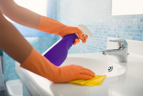 Close-up of a cleaner treating sofa stains in a Lambeth property
